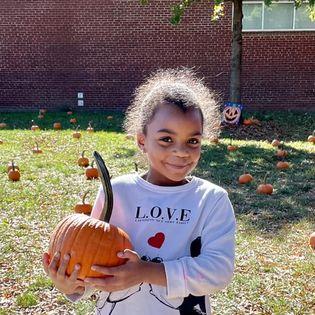 Girl holding pumpkin